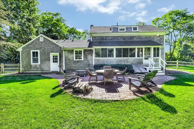 a view of a house with a yard porch and sitting area
