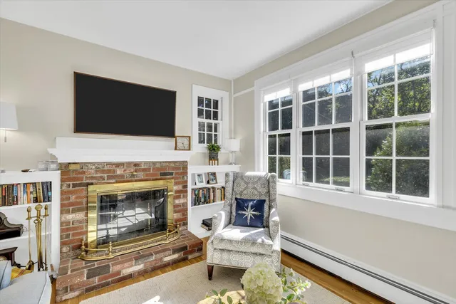 a living room with furniture a fireplace and a flat screen tv