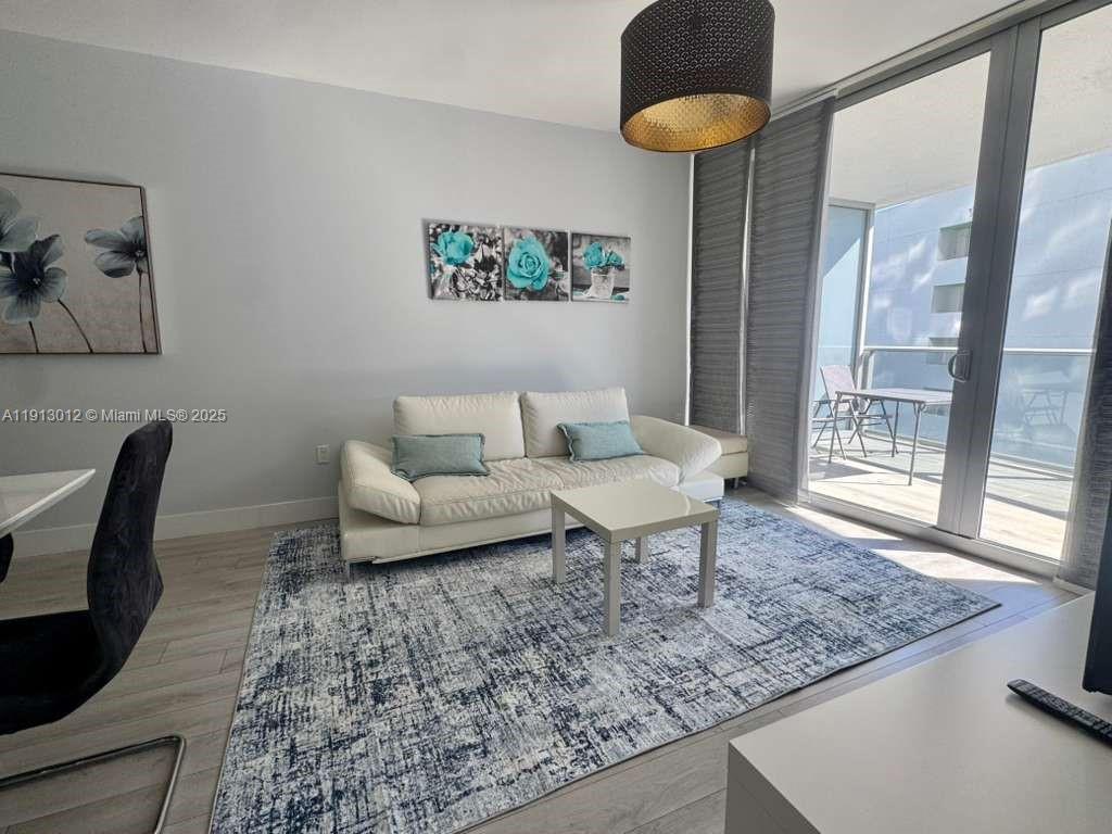 488 Northeast 18th Street, Unit 3208 Miami, FL 33132 - Photo 14 of 17 a living room with furniture and a rug