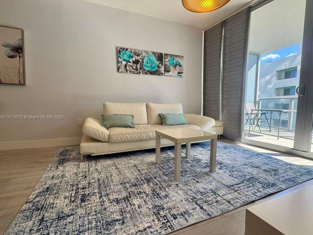 488 Northeast 18th Street, Unit 3208 Miami, FL 33132 - Photo 15 of 17 a living room with furniture and a rug
