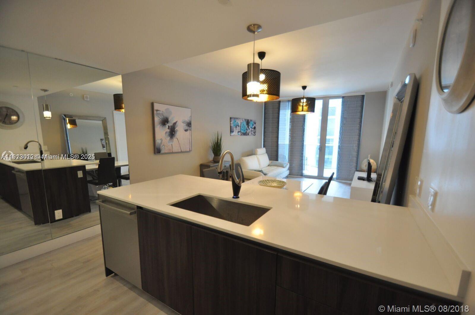 488 Northeast 18th Street, Unit 3208 Miami, FL 33132 - Photo 16 of 17 a kitchen with a sink and a refrigerator