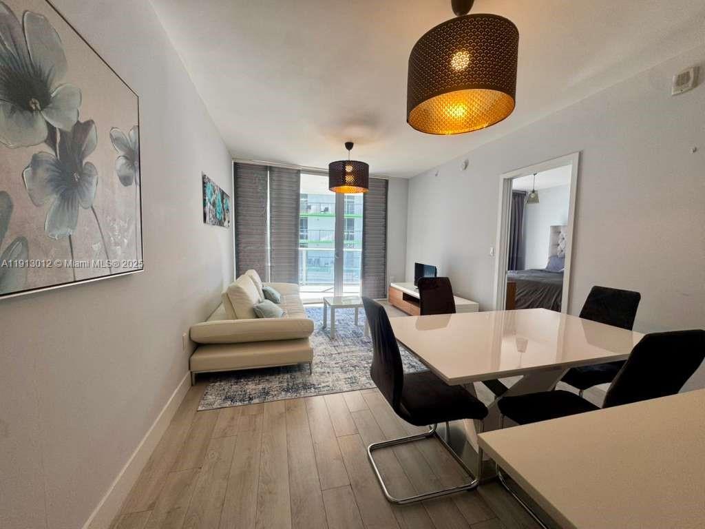 488 Northeast 18th Street, Unit 3208 Miami, FL 33132 - Photo 2 of 17 a living room with furniture and a large window