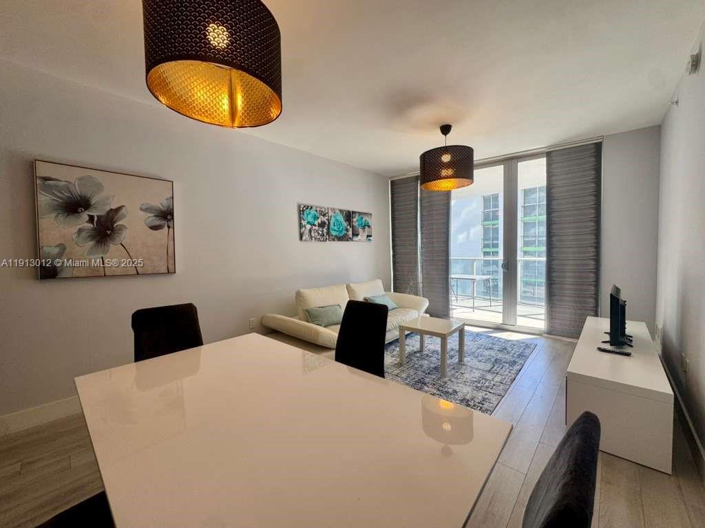 488 Northeast 18th Street, Unit 3208 Miami, FL 33132 - Photo 3 of 17 a bedroom with a bed and a painting on the wall