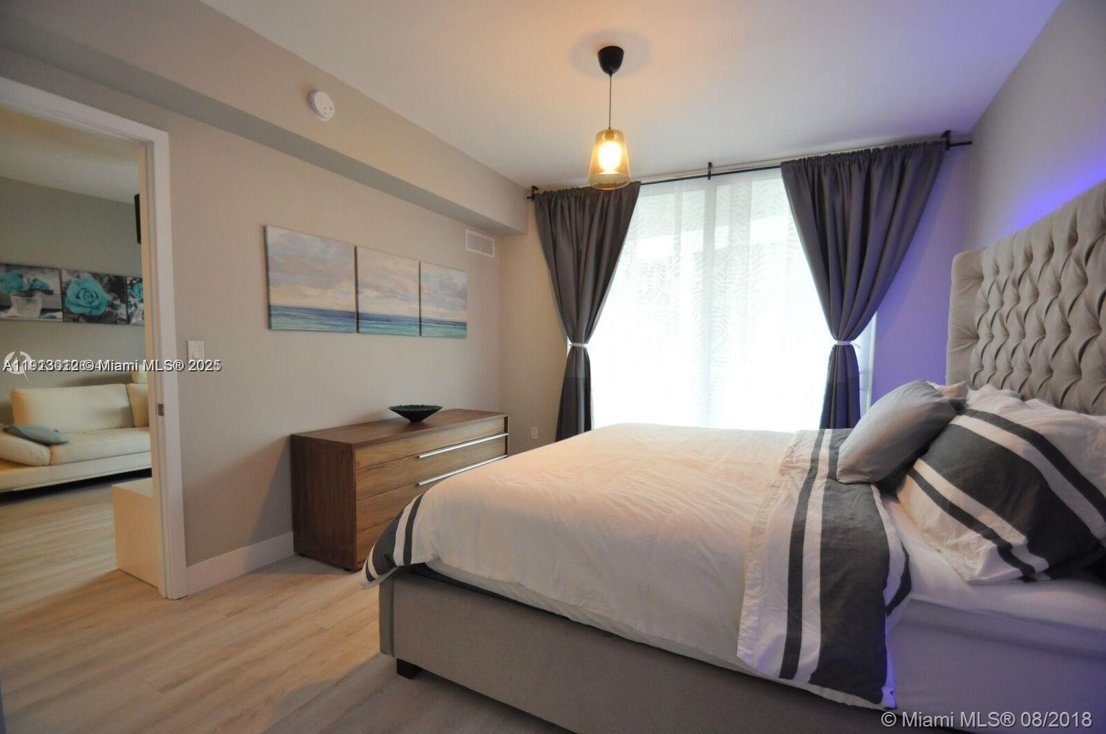 488 Northeast 18th Street, Unit 3208 Miami, FL 33132 - Photo 6 of 17 a bedroom with a bed and a window