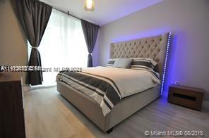 488 Northeast 18th Street, Unit 3208 Miami, FL 33132 - Photo 7 of 17 a bedroom with a bed and a potted plant