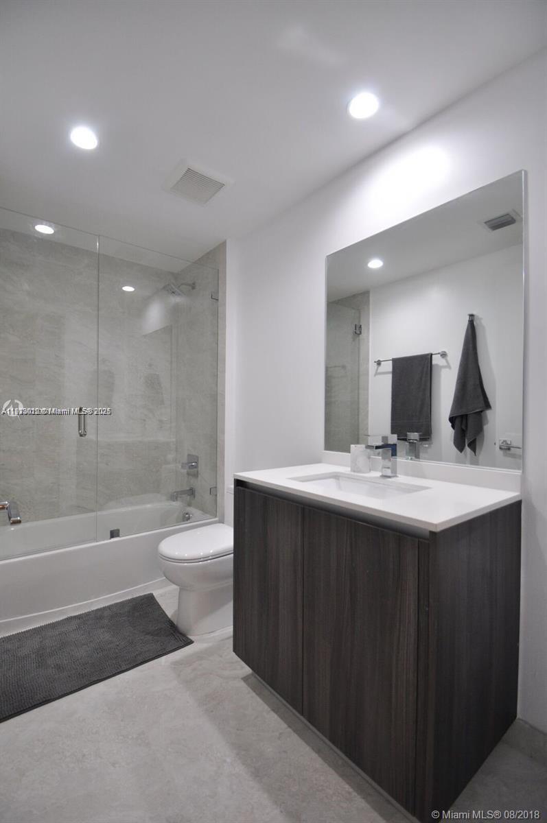 488 Northeast 18th Street, Unit 3208 Miami, FL 33132 - Photo 10 of 17 a bathroom with a bathtub shower sink and toilet
