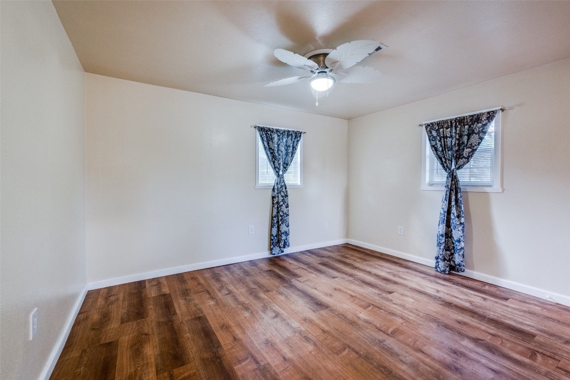 1200 West Phillips Street Alvin, TX 77511 - Photo 13 of 31 a view of a room with a hanging light and hardwood floor