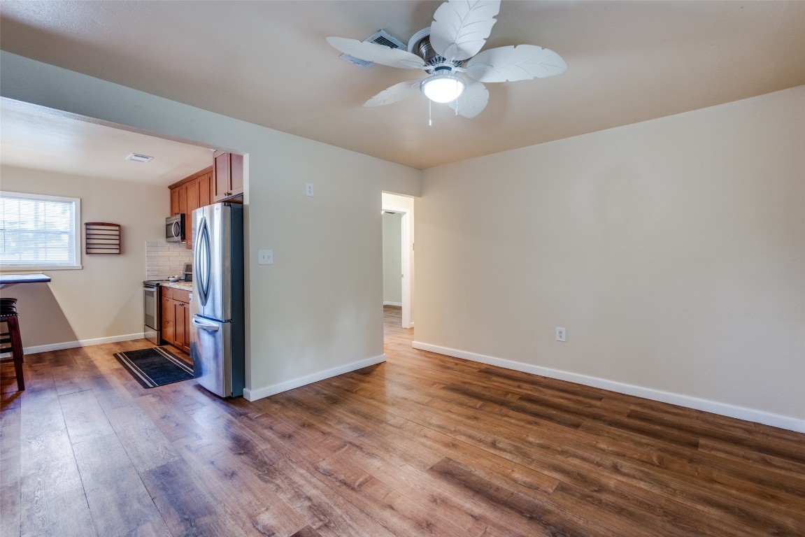 1200 West Phillips Street Alvin, TX 77511 - Photo 14 of 31 wooden floor in an empty room with a window