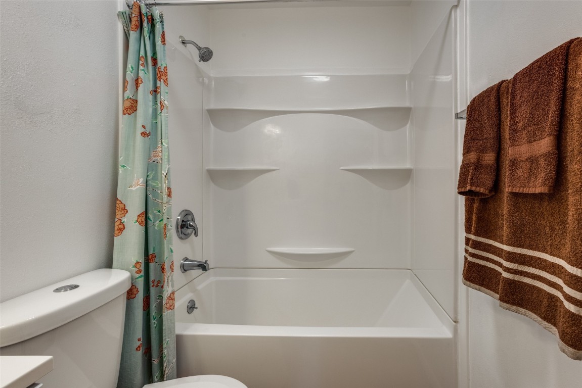 1200 West Phillips Street Alvin, TX 77511 - Photo 15 of 31 a bathroom with a bathtub and a shower