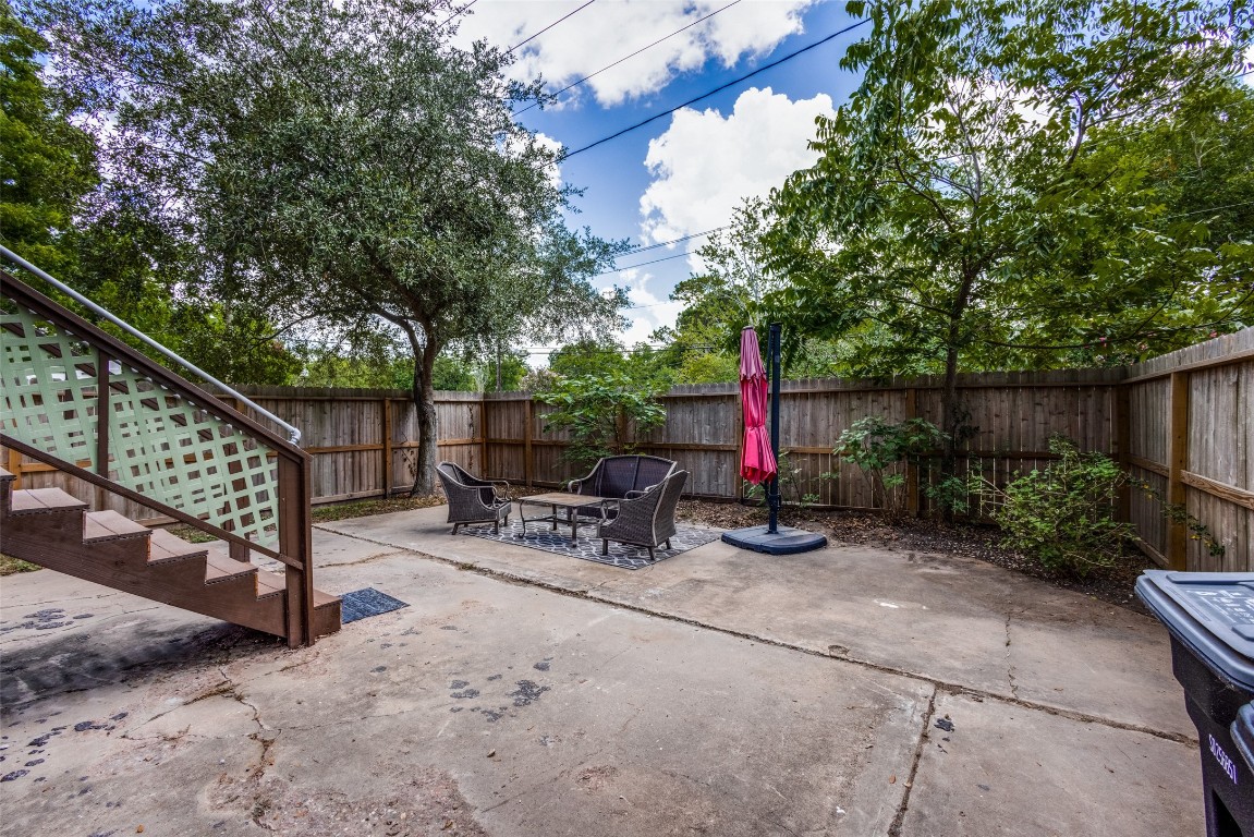 1200 West Phillips Street Alvin, TX 77511 - Photo 26 of 31 a view of backyard with sitting area and wooden fence