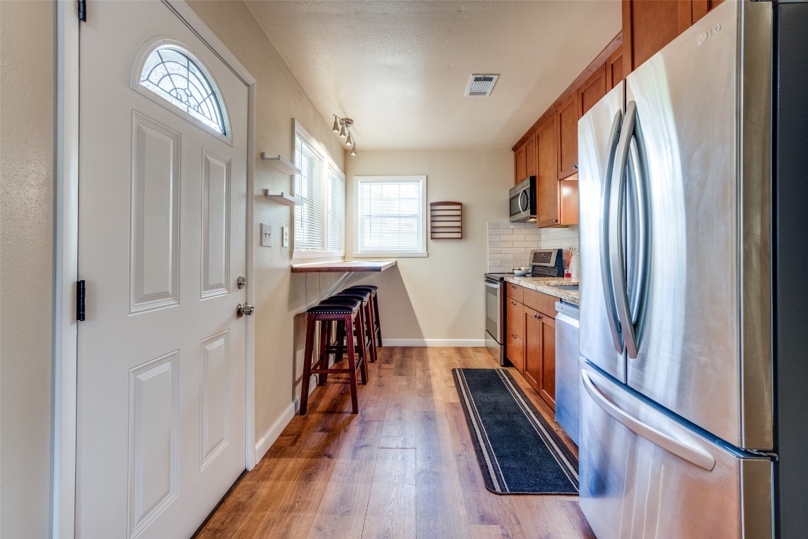 1200 West Phillips Street Alvin, TX 77511 - Photo 6 of 31 a view of a kitchen with a refrigerator and a window