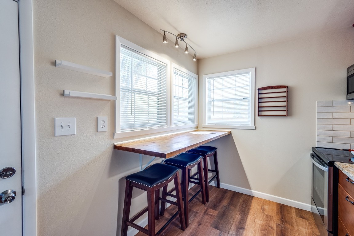1200 West Phillips Street Alvin, TX 77511 - Photo 9 of 31 a dining room with wooden floor and breakfast area