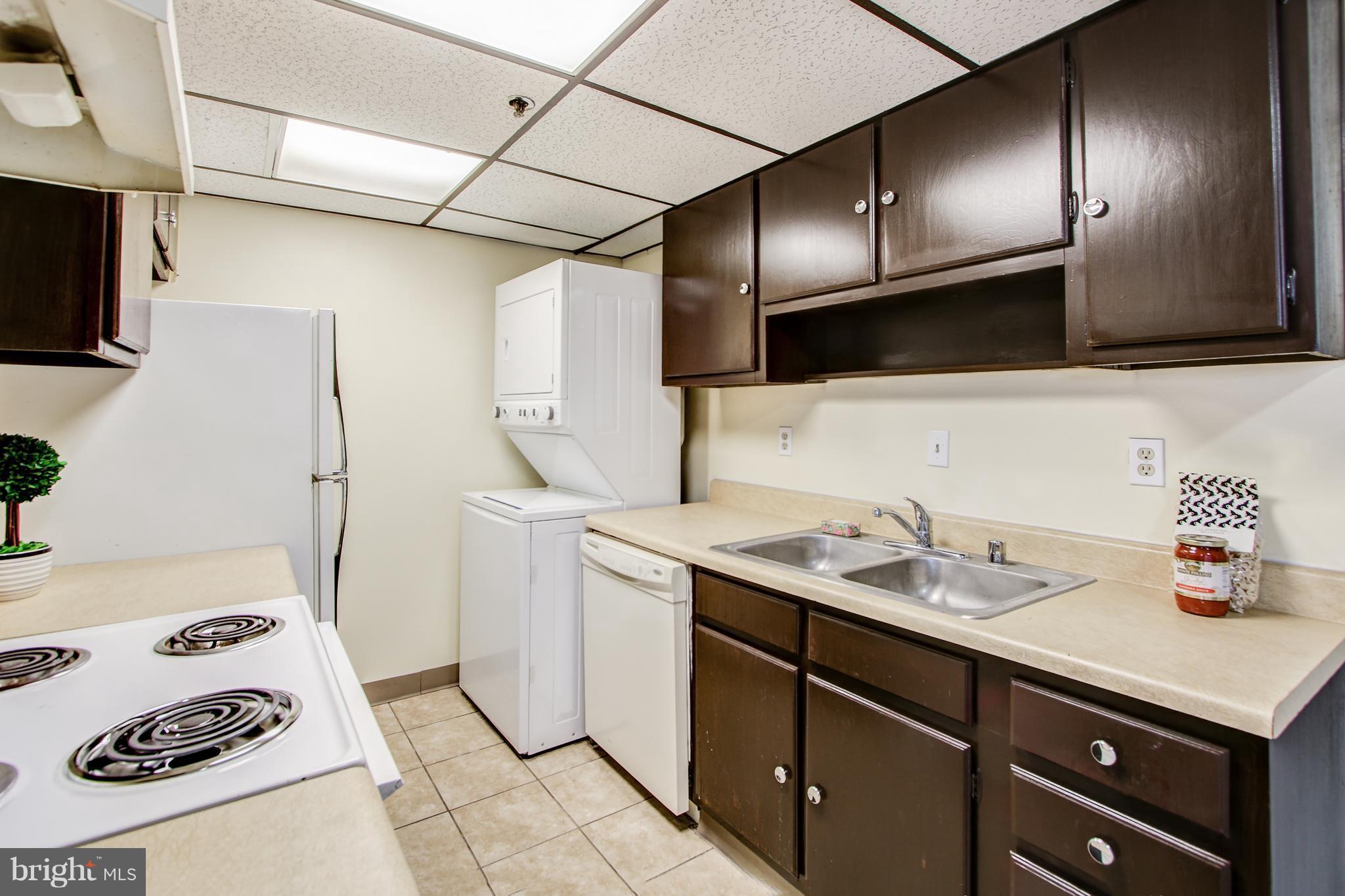 5911 Edsall Road, Unit 902 Alexandria, VA 22304 - Photo 13 of 26 a kitchen with a sink and a refrigerator