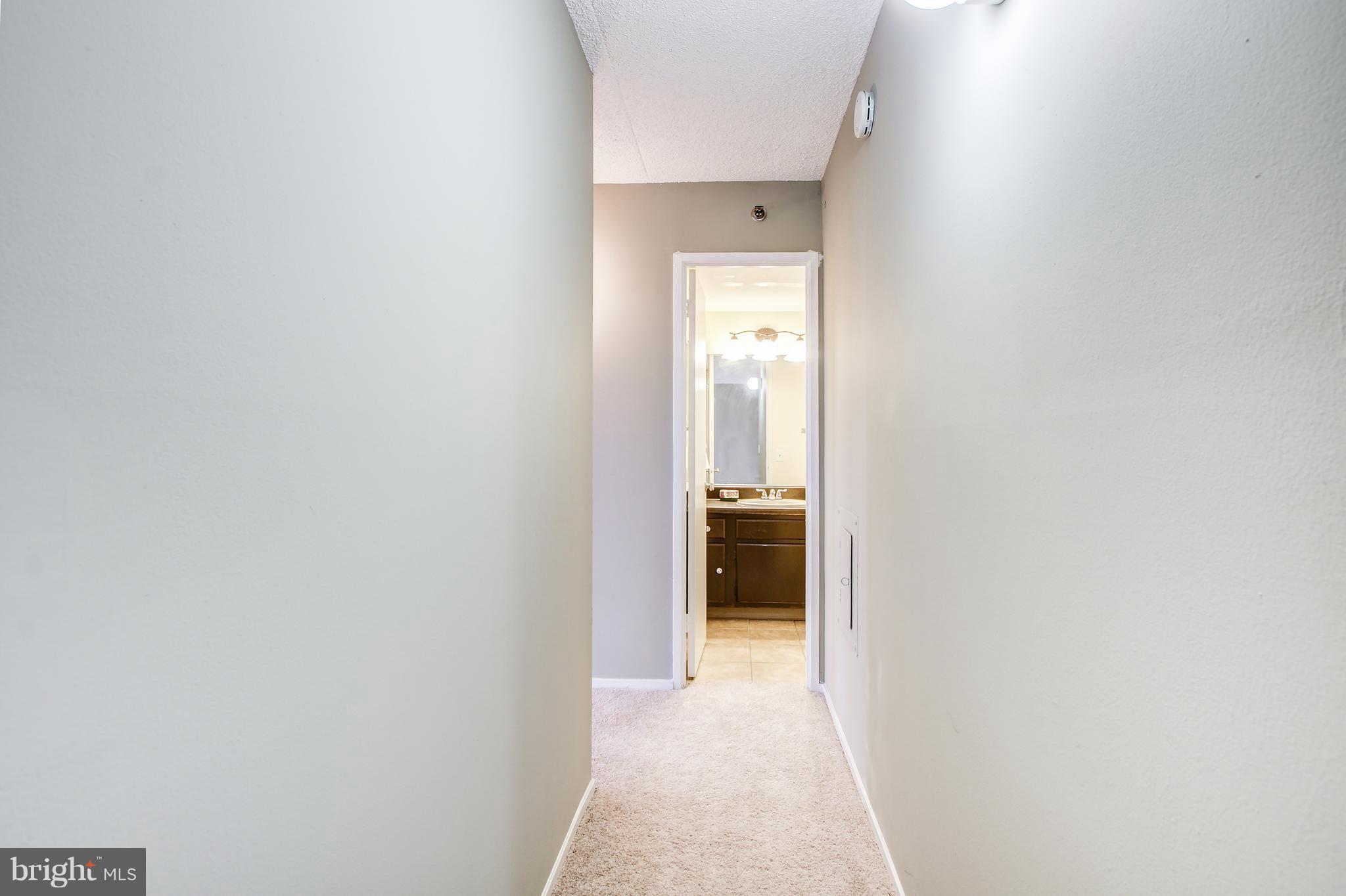 5911 Edsall Road, Unit 902 Alexandria, VA 22304 - Photo 14 of 26 a view of a bathroom from a hallway