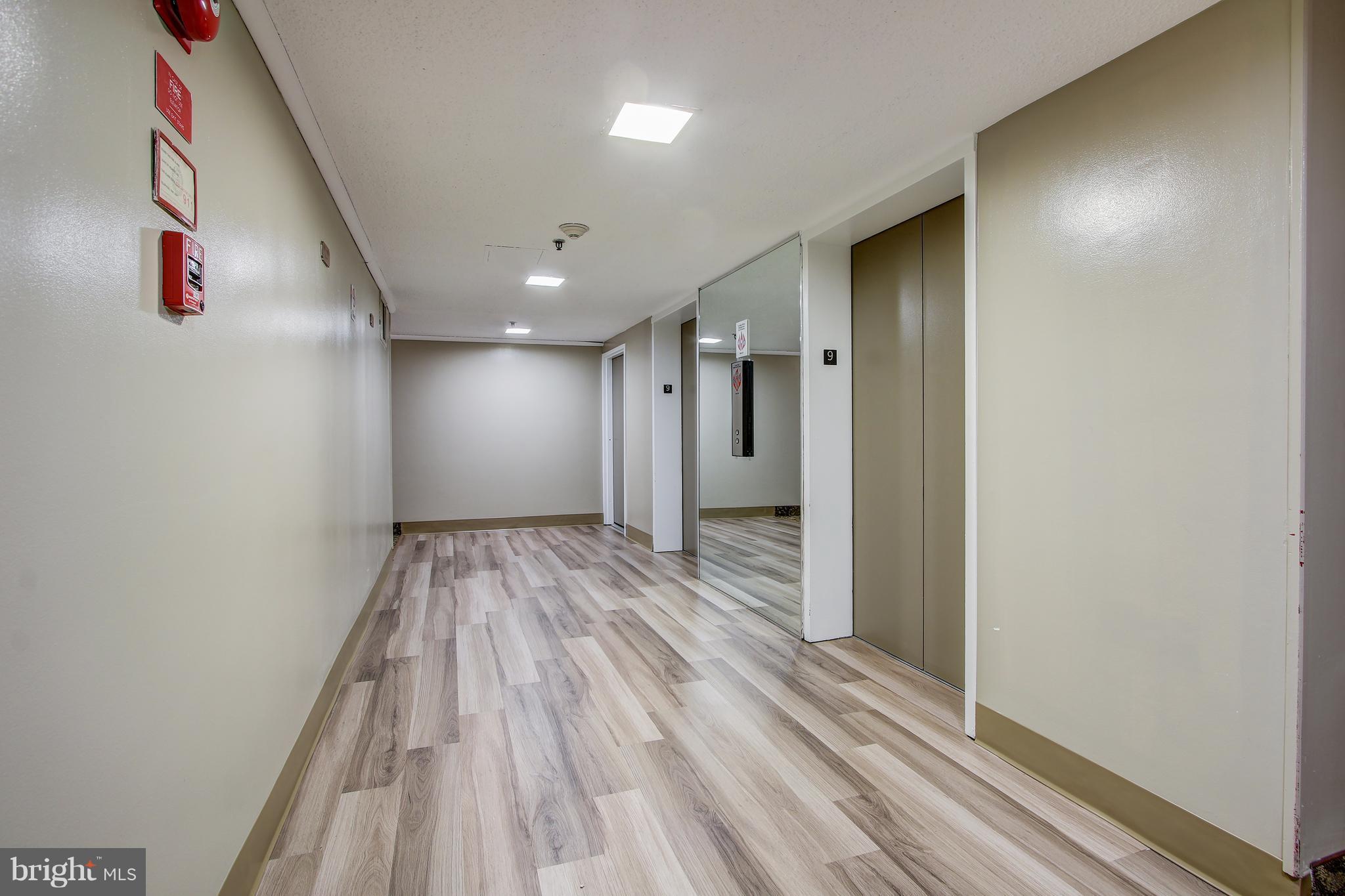 5911 Edsall Road, Unit 902 Alexandria, VA 22304 - Photo 3 of 26 a view of hallway with wooden floor