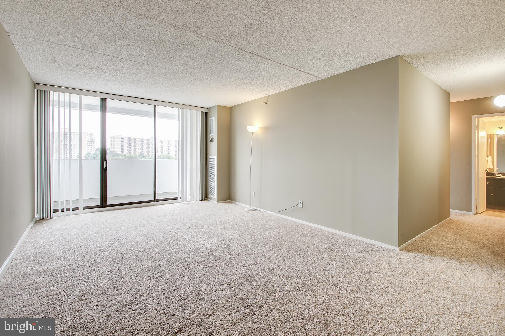 5911 Edsall Road, Unit 902 Alexandria, VA 22304 - Photo 4 of 26 a view of an empty room with a window