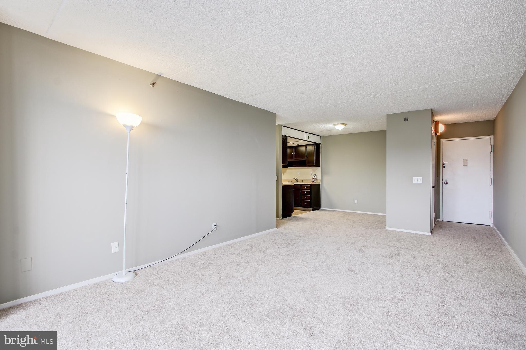 5911 Edsall Road, Unit 902 Alexandria, VA 22304 - Photo 6 of 26 a view of an empty room with a kitchen