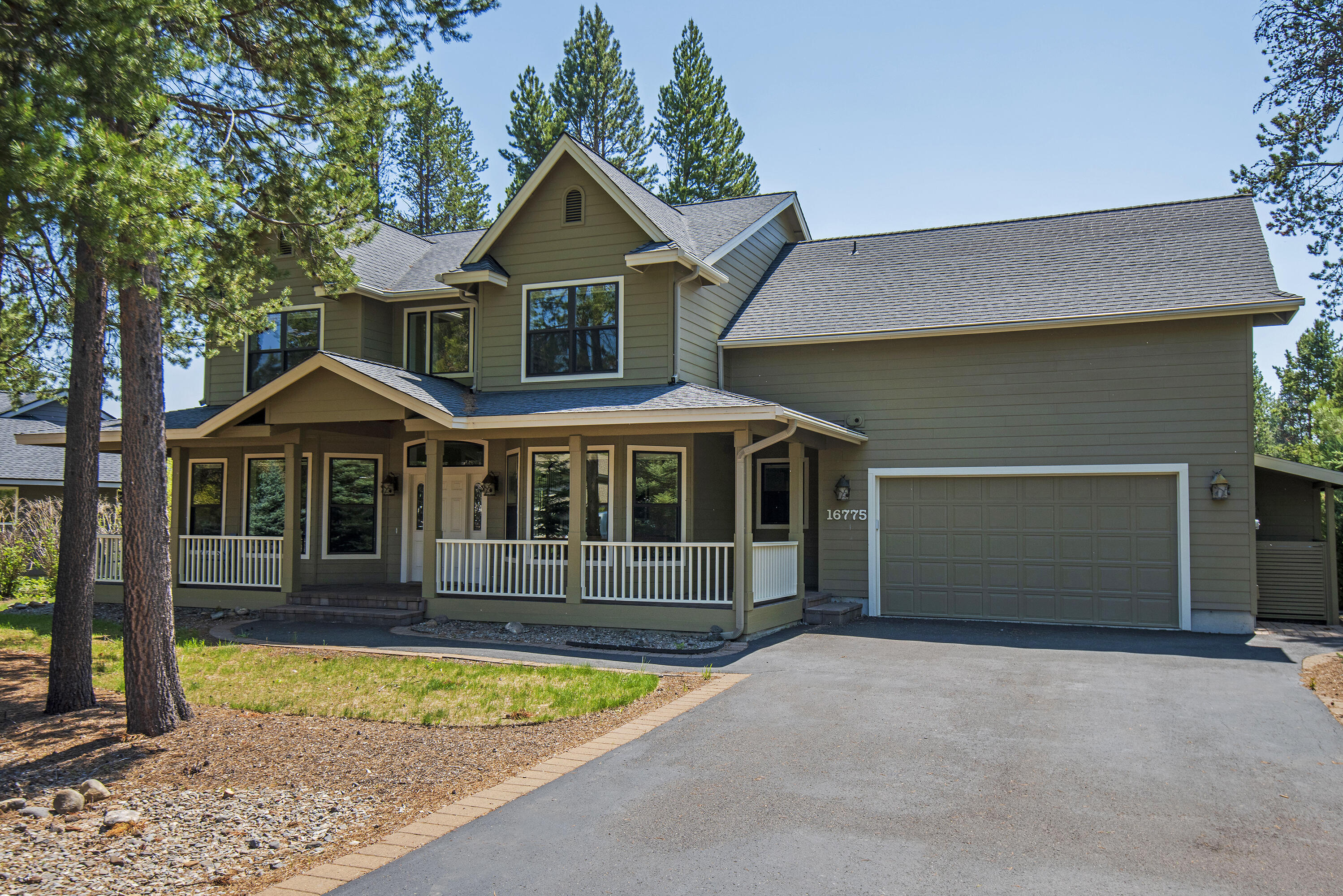 16775 Pony Express Way Bend, OR 97707 - Photo 2 of 38 a front view of a house with a yard and garage