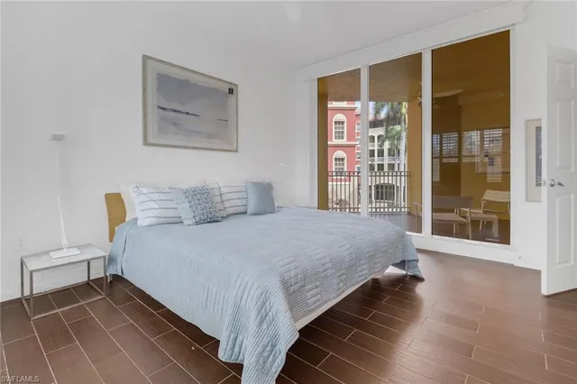 a bedroom with a bed and a large window