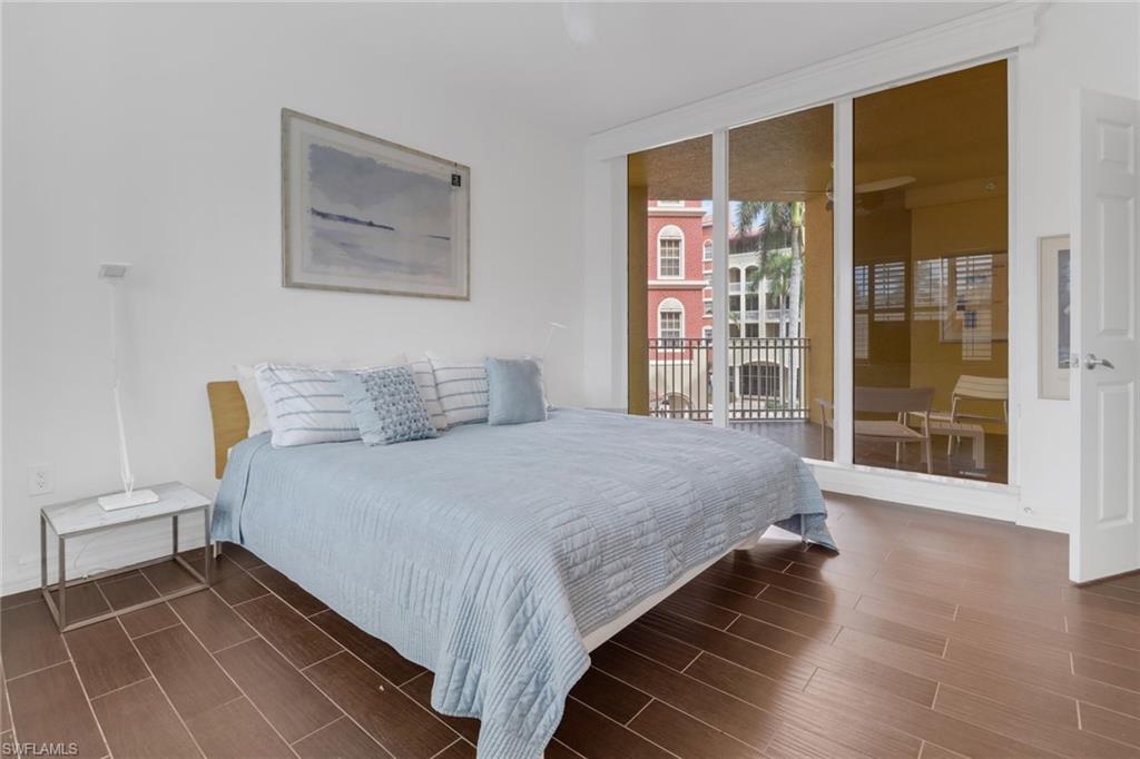 450 Bayfront Place, Unit 4201 Naples, FL 34102 - Photo 9 of 23 a bedroom with a bed and a large window