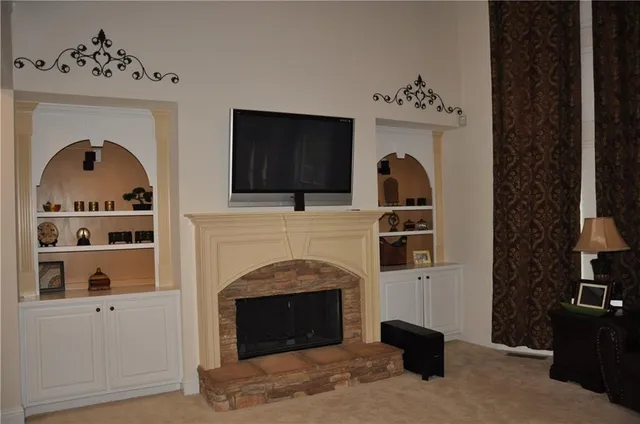 a living room with furniture and a fireplace