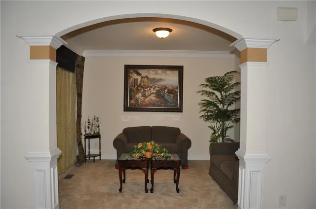a living room with furniture and a potted plant