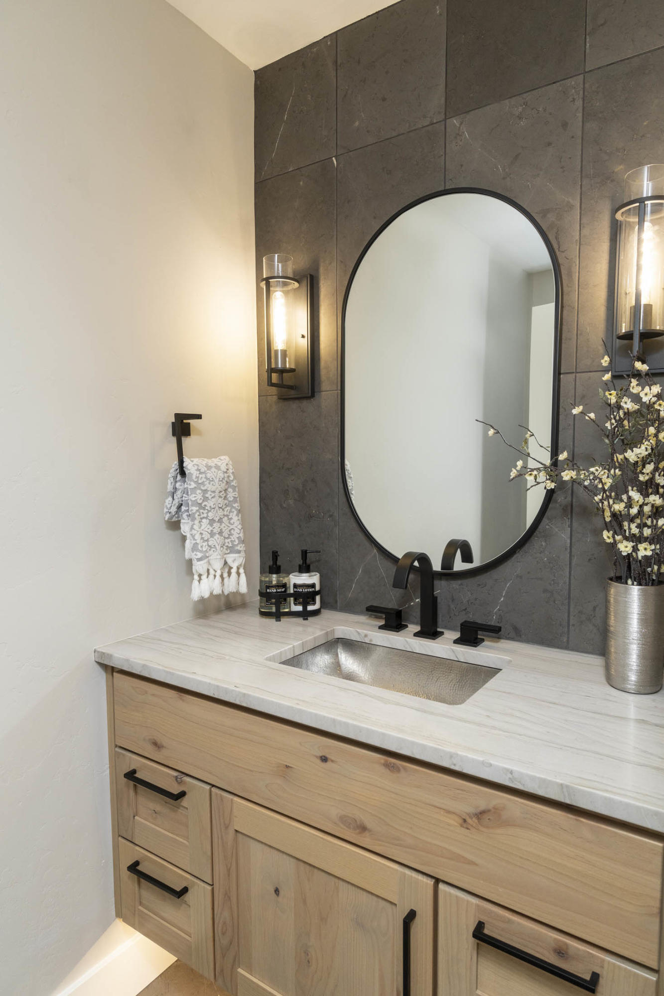 64486 McGrath Road Bend, OR 97701 - Photo 15 of 38 Upstairs powder room with translucent quartzite counters and hammered stainless sink.