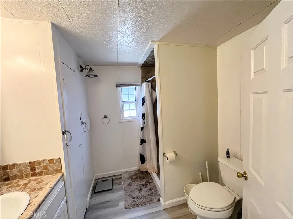 17700 Avalon, Unit 40 Carson, CA 90746 - Photo 22 of 32 a bathroom with a granite countertop sink toilet and shower