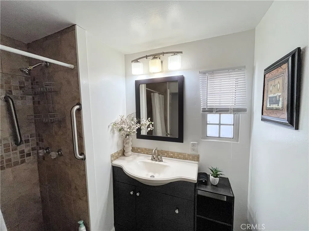 17700 Avalon, Unit 40 Carson, CA 90746 - Photo 27 of 32 a bathroom with a sink a mirror and a shower