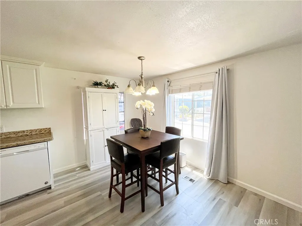 17700 Avalon, Unit 40 Carson, CA 90746 - Photo 9 of 32 a view of a dining room with furniture window and wooden floor