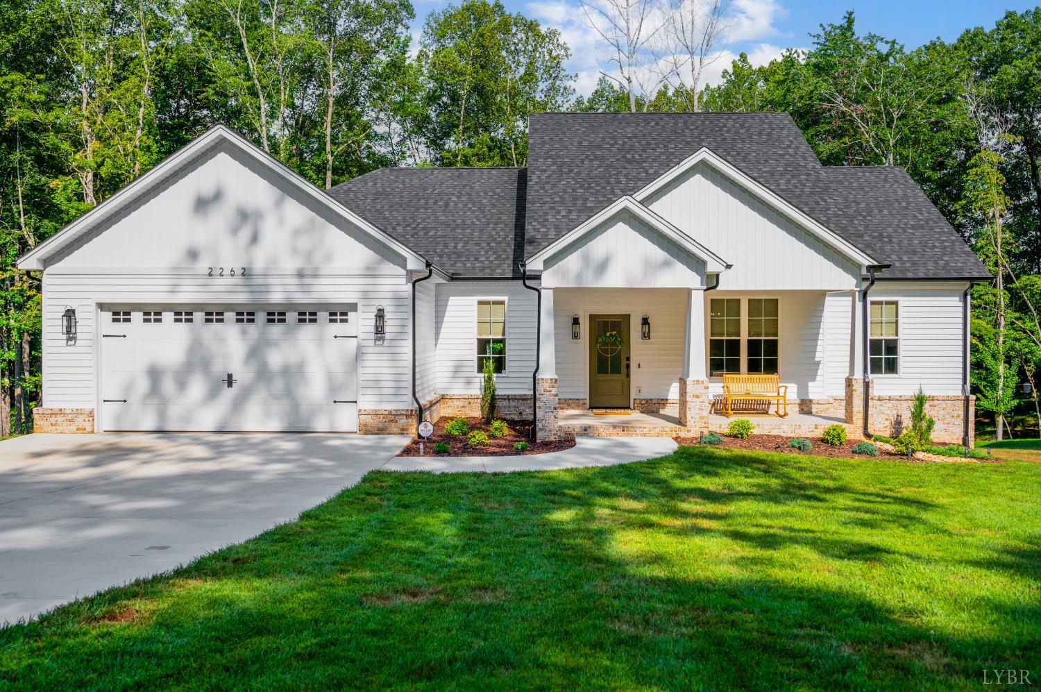 a view of a house with backyard and porch