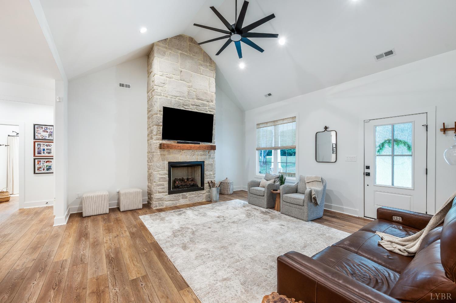2262 Hooper Road Forest, VA 24551 - Photo 22 of 80 a living room with furniture a fireplace and a flat screen tv