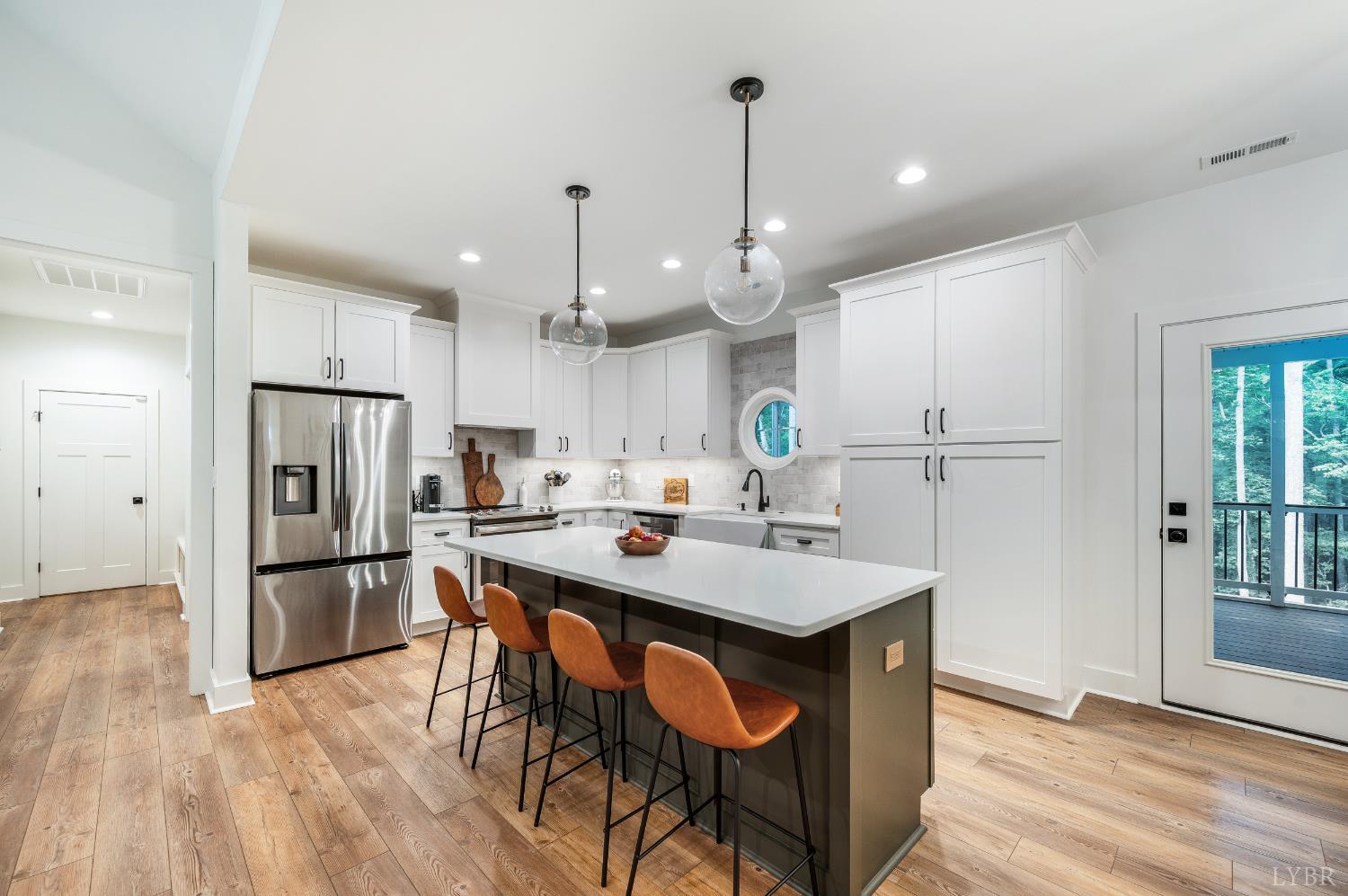 2262 Hooper Road Forest, VA 24551 - Photo 30 of 80 a kitchen with a refrigerator a sink and chairs
