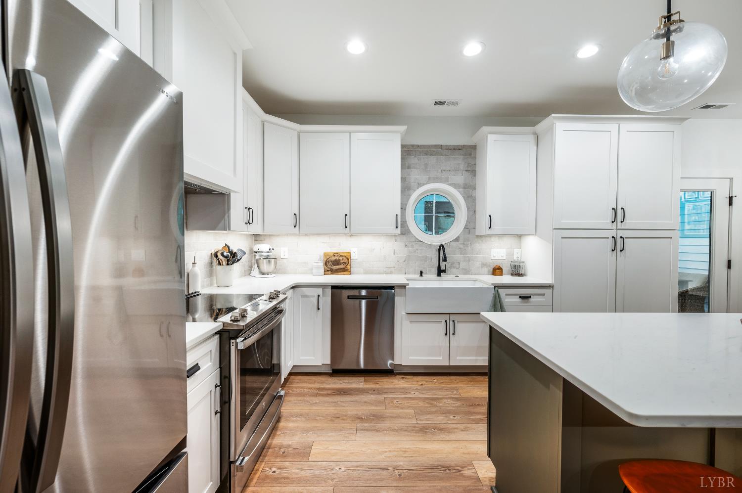 2262 Hooper Road Forest, VA 24551 - Photo 31 of 80 a kitchen with stainless steel appliances granite countertop a refrigerator a sink dishwasher a stove and white countertops with wooden floor