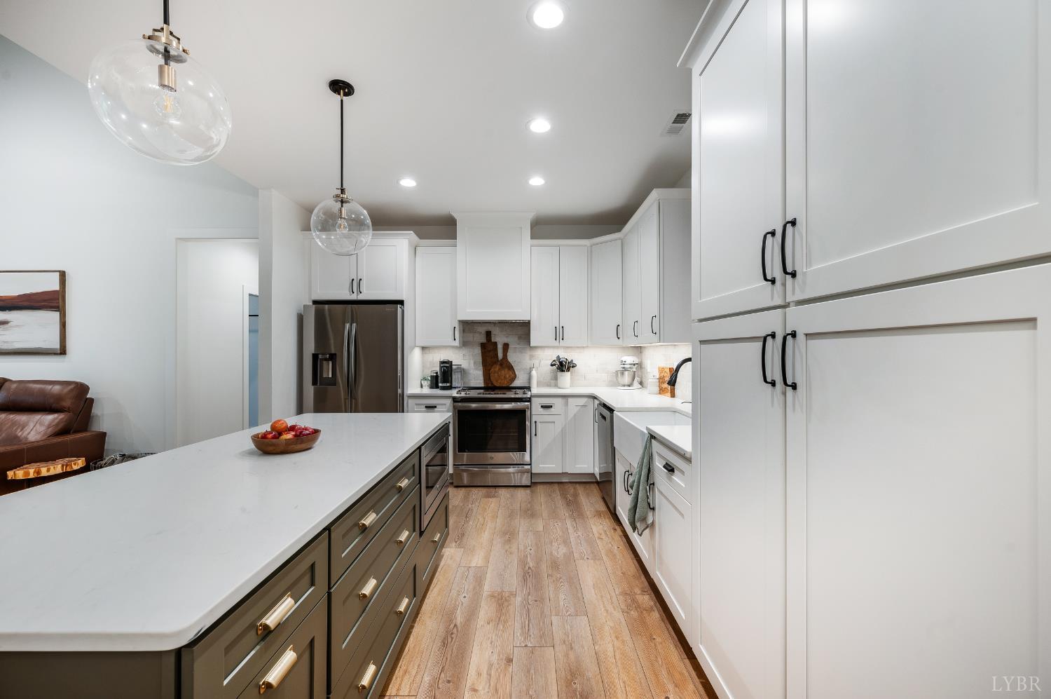 2262 Hooper Road Forest, VA 24551 - Photo 32 of 80 a kitchen with a refrigerator a sink and wooden floor