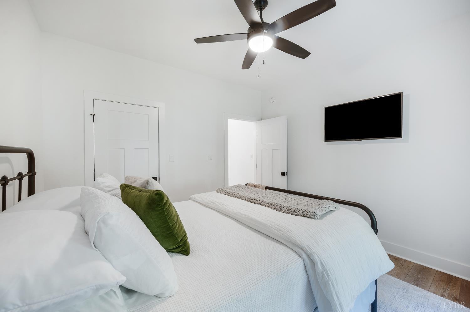 2262 Hooper Road Forest, VA 24551 - Photo 46 of 80 a bedroom with a bed and a flat screen tv