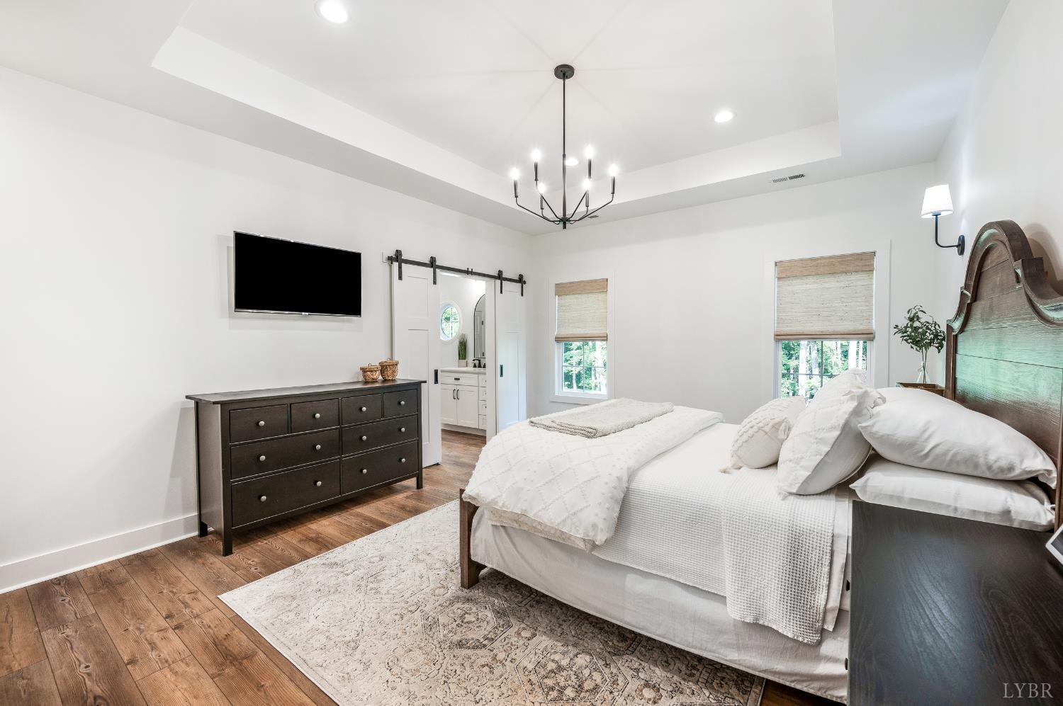 2262 Hooper Road Forest, VA 24551 - Photo 53 of 80 a bedroom with a bed and a flat screen tv