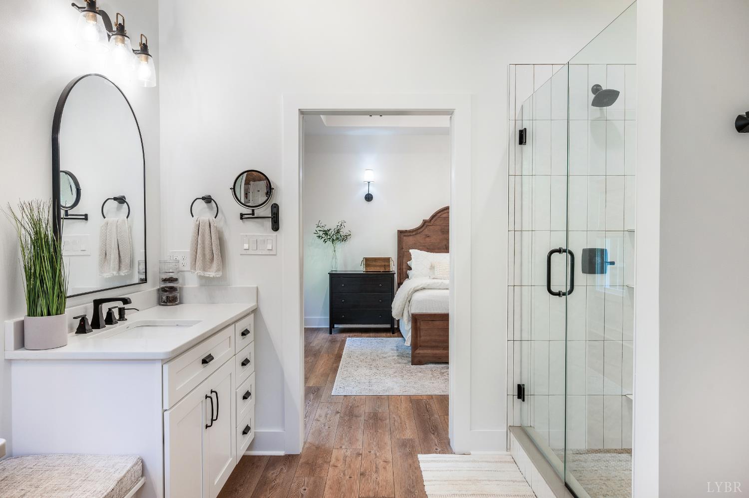 2262 Hooper Road Forest, VA 24551 - Photo 59 of 80 a en suite bathroom with a double vanity sink a mirror and shower