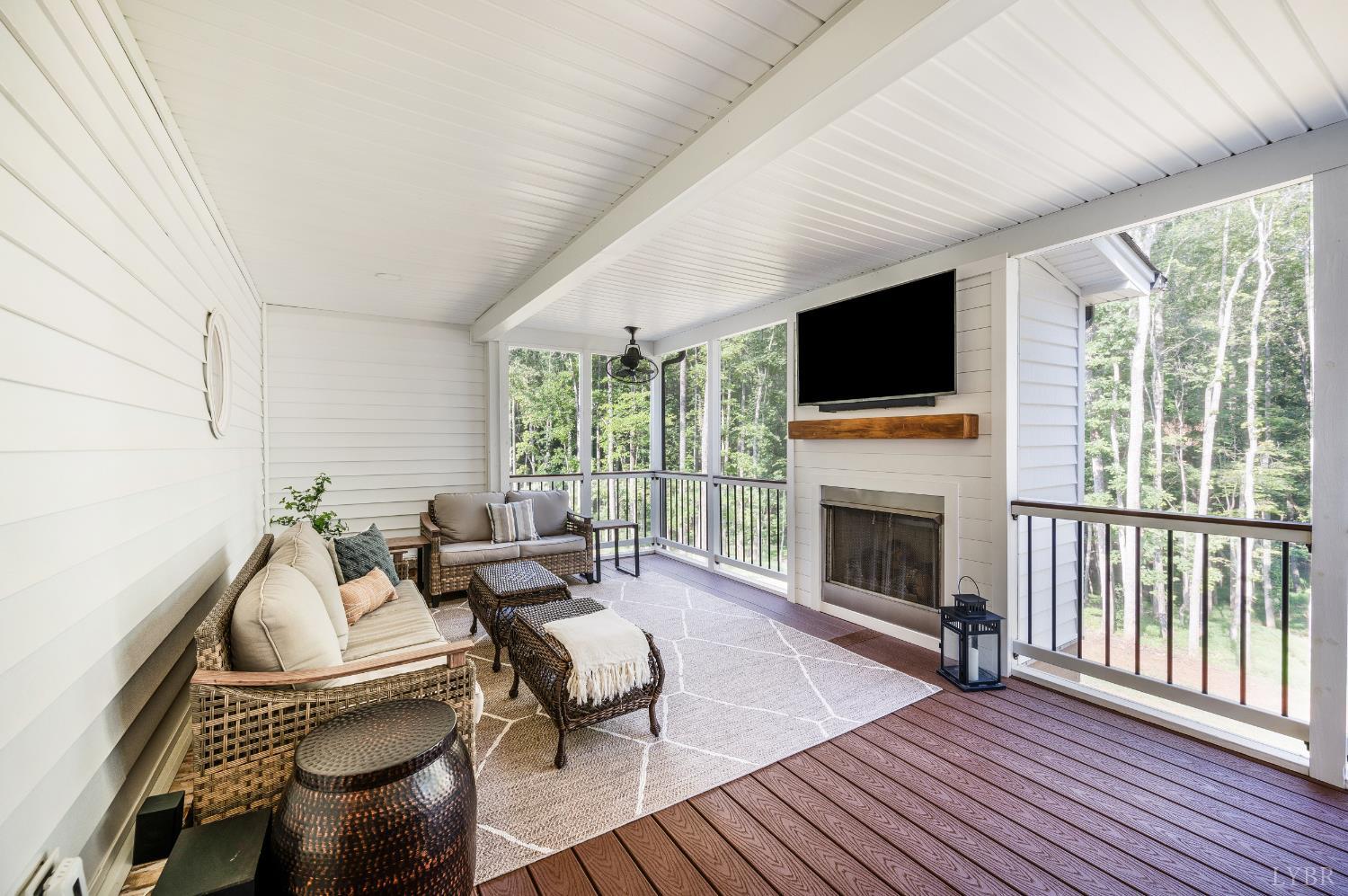 2262 Hooper Road Forest, VA 24551 - Photo 65 of 80 a living room with furniture a flat screen tv and a fireplace