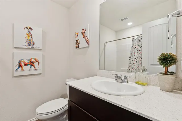 a bathroom with a sink toilet and a mirror