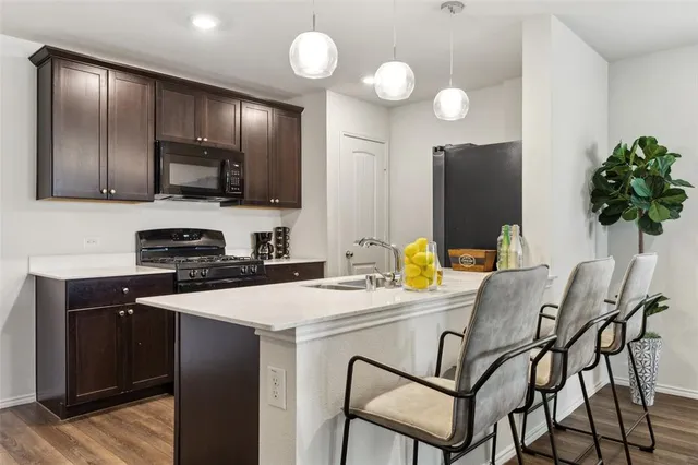 a kitchen with a sink cabinets and stainless steel appliances
