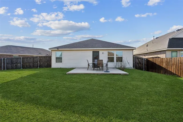 a front view of a house with a garden and yard