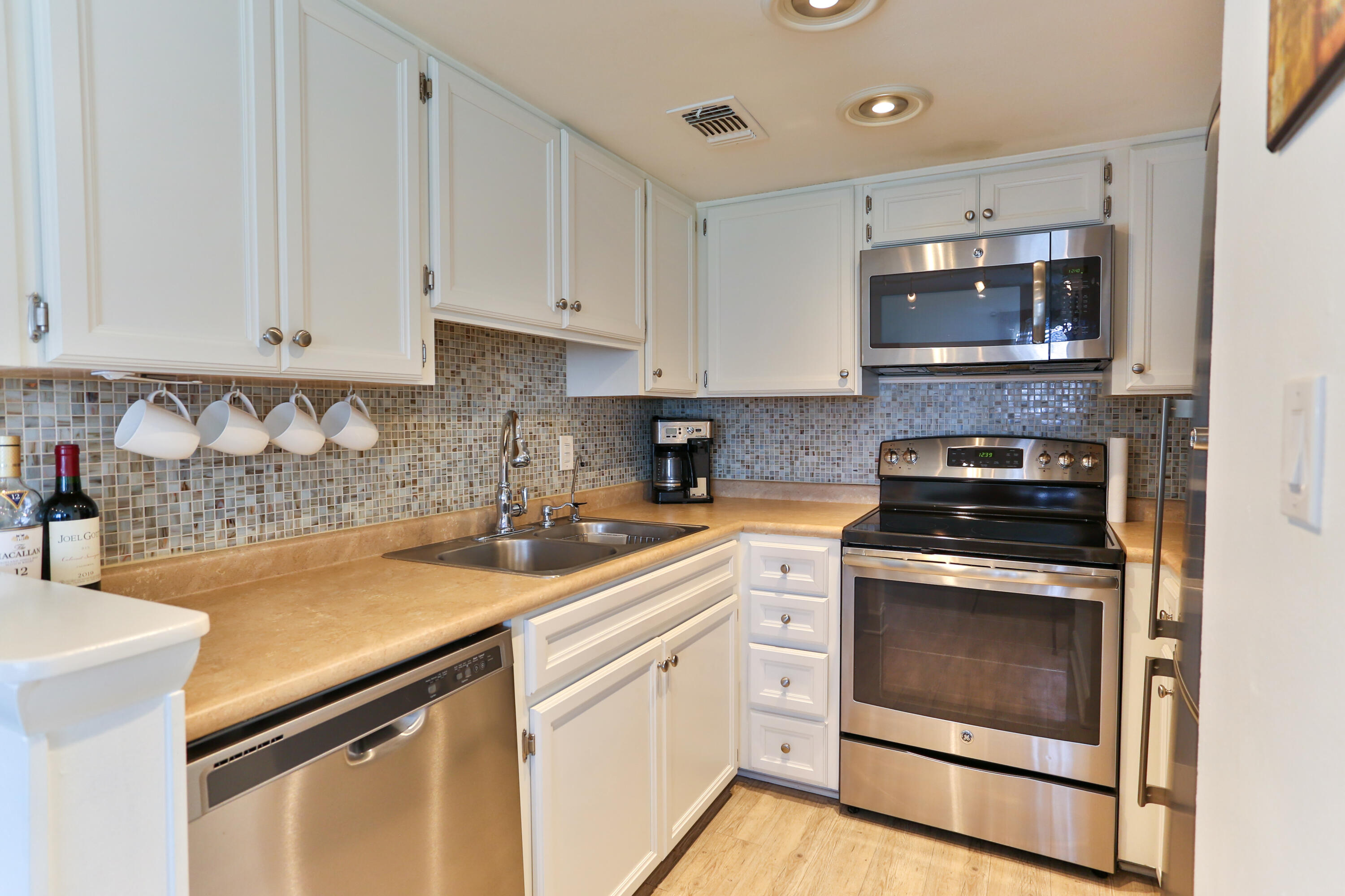 101 Old Ferry Road, Unit 1D Shalimar, FL 32579 - Photo 1 of 34 a kitchen with a sink stove and microwave