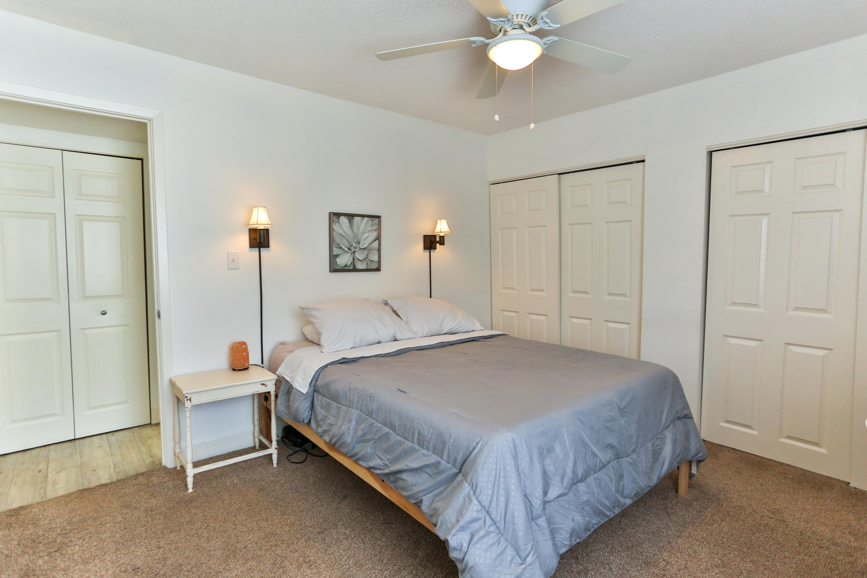 101 Old Ferry Road, Unit 1D Shalimar, FL 32579 - Photo 16 of 34 a bedroom with a bed and a chandelier
