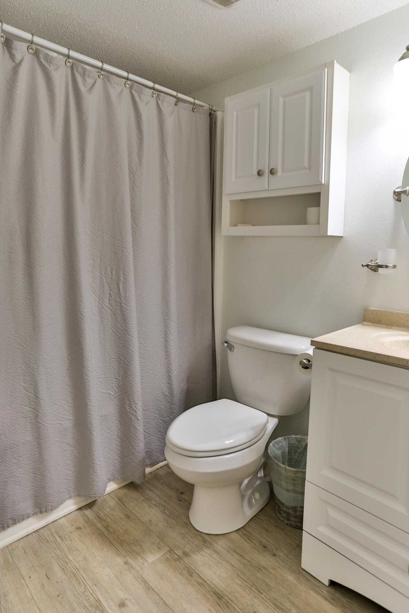 101 Old Ferry Road, Unit 1D Shalimar, FL 32579 - Photo 20 of 34 a bathroom with a toilet and a shower curtain