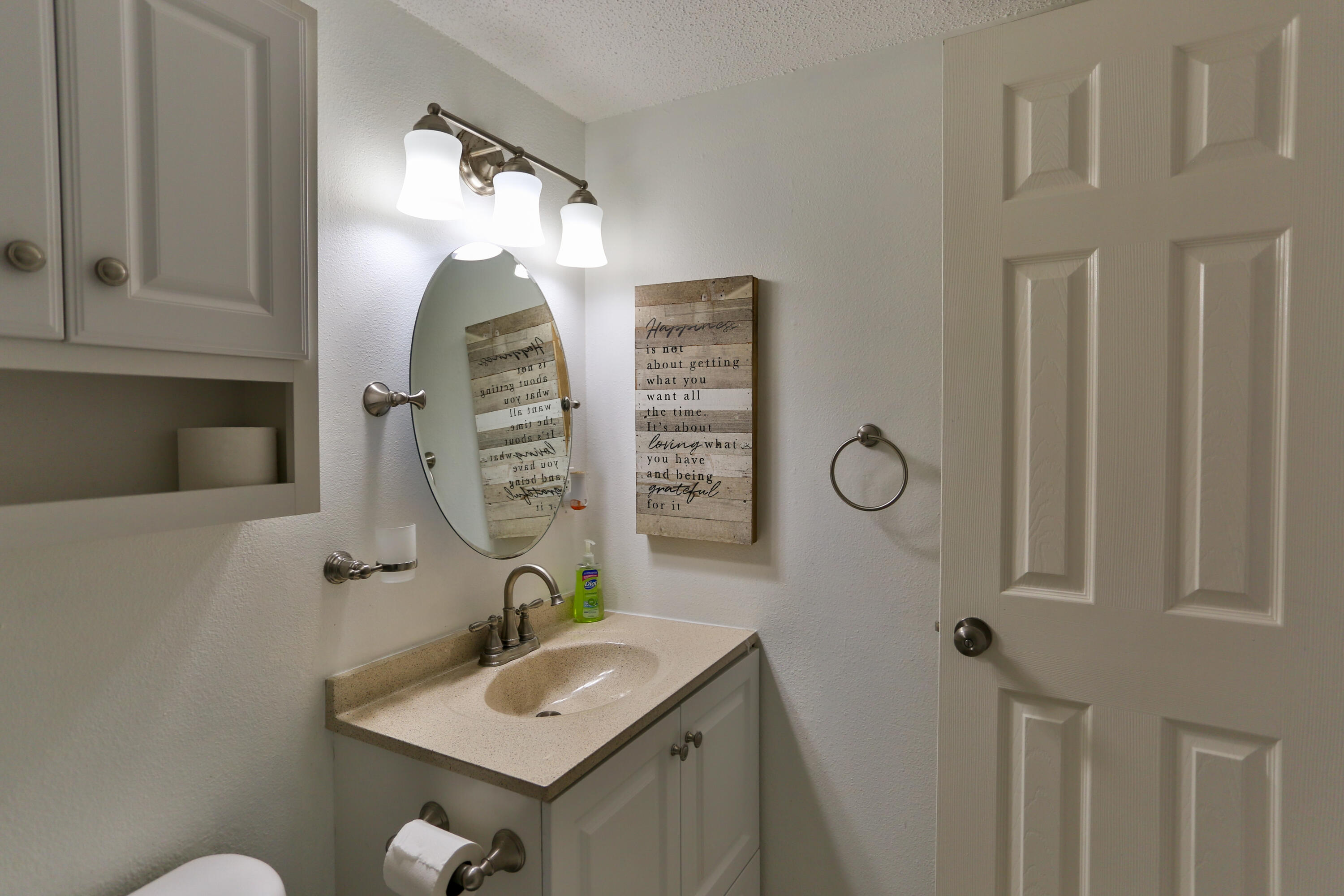 101 Old Ferry Road, Unit 1D Shalimar, FL 32579 - Photo 21 of 34 a bathroom with a sink and mirror with toilet
