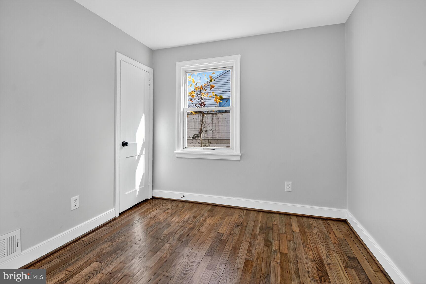 2814 Munson Street Silver Spring, MD 20902 - Photo 11 of 21 an empty room with wooden floor and window