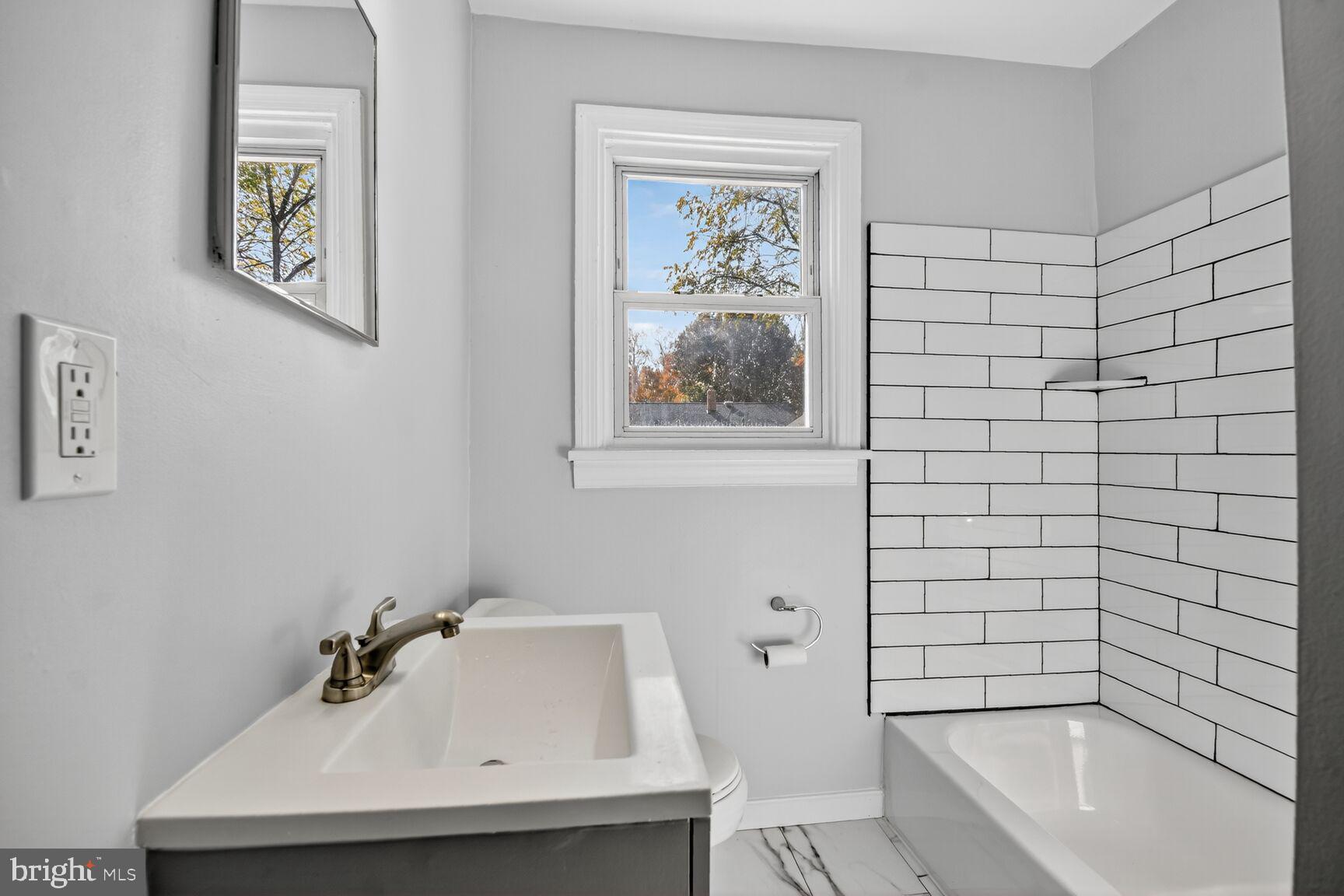 2814 Munson Street Silver Spring, MD 20902 - Photo 4 of 21 a bathroom with a sink and a bathtub