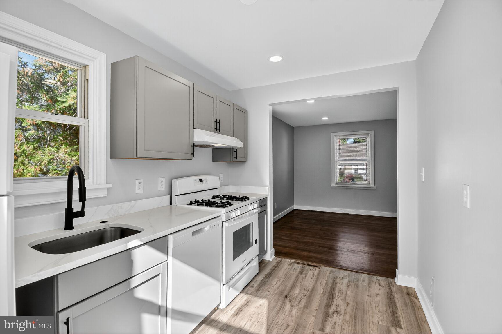2814 Munson Street Silver Spring, MD 20902 - Photo 9 of 21 a kitchen with stainless steel appliances a sink stove and cabinets