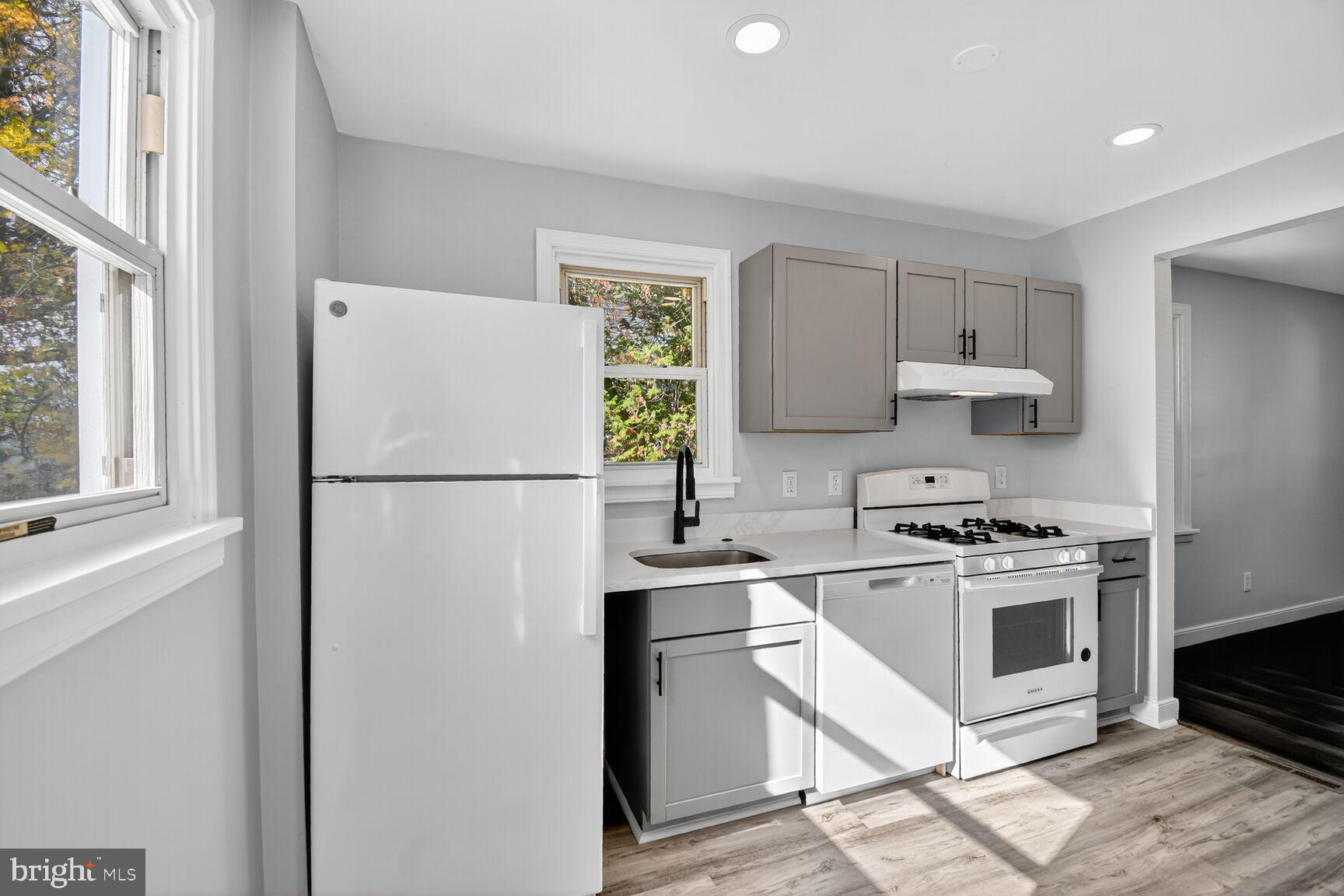 2814 Munson Street Silver Spring, MD 20902 - Photo 10 of 21 a kitchen with a stove a refrigerator and a sink